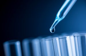 Pippette Dripping Into Test Tubes